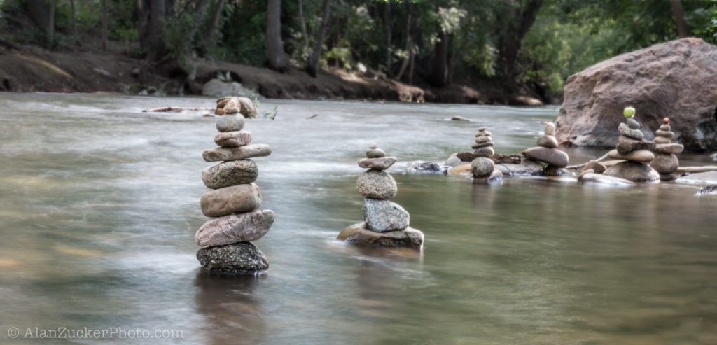 photo of rock cairns in creek